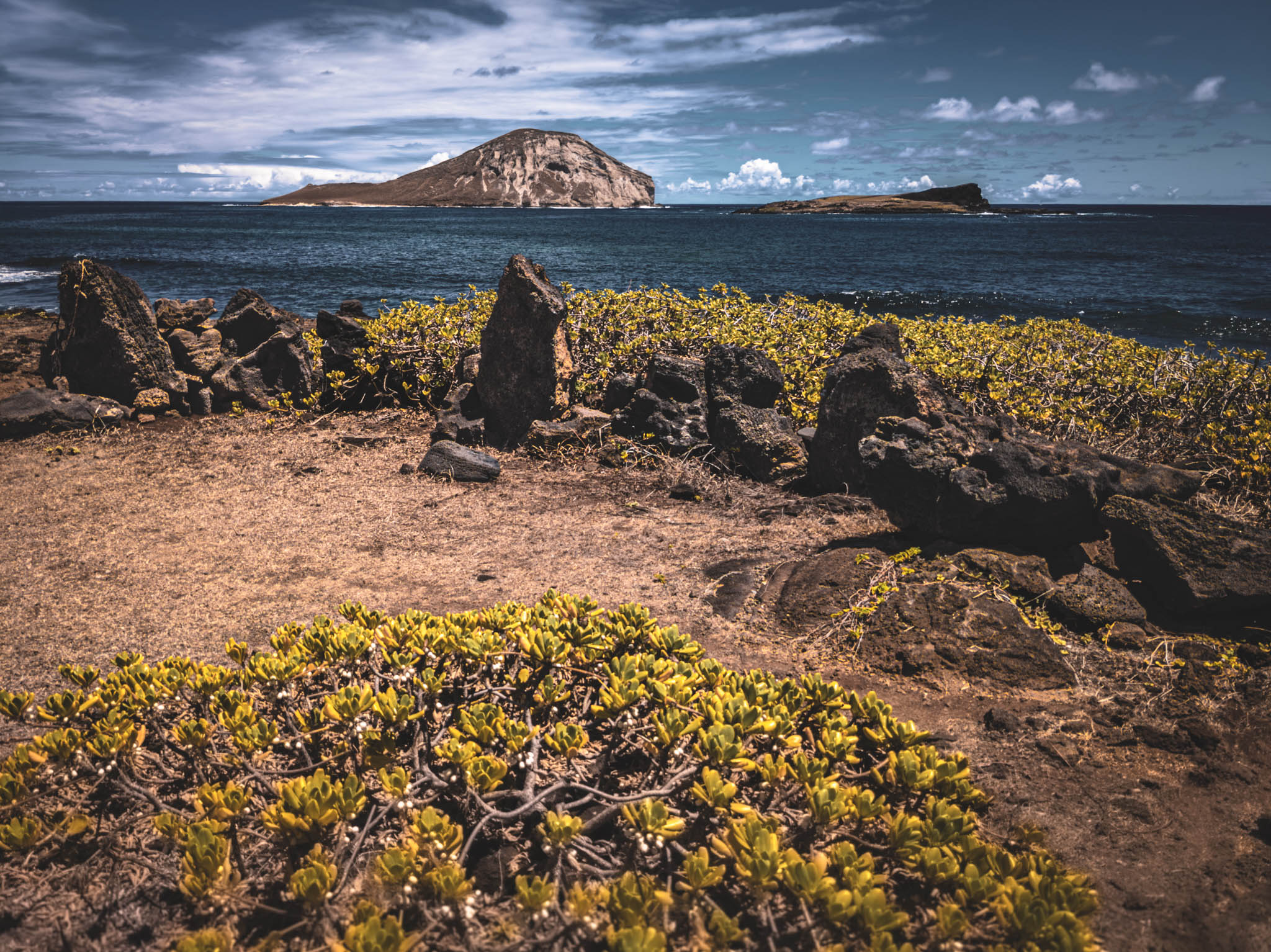 Makapu’u Heiau, Kalanianaʻole Highway, Oahu Island (photo 17 August 2021), with Kāohikaipu Islet (R) and Mānana Island (L) in far background.