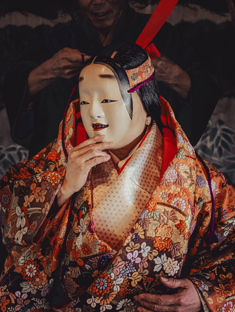 Sado Daizen Shrine Noh Stage, Takeda, Sado Island, rebuilt 1846 (Nov. 6, 2025): KY wearing antique 万媚 (Manbi, demon disguised as a young woman) nō-men and Karaori robe.