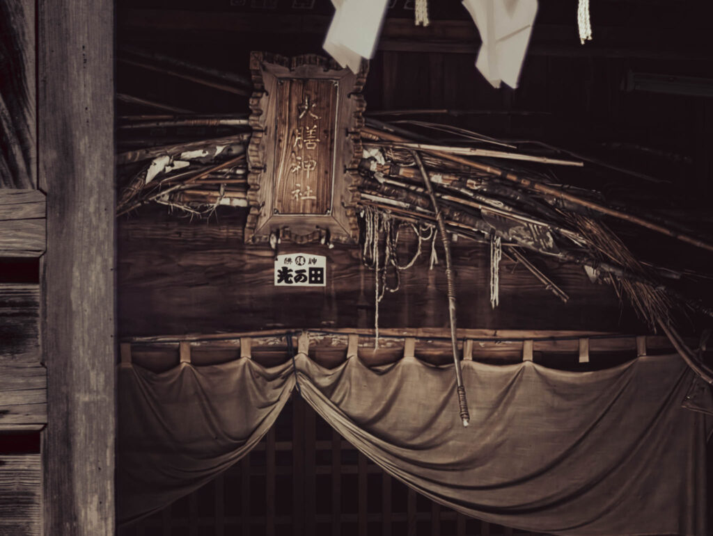 Daizen Shrine, Takeda, Sado Island, (photo Nov. 6, 2025): ancient bows and arrows tucked behind inscribed plaque, haiden (oratory).