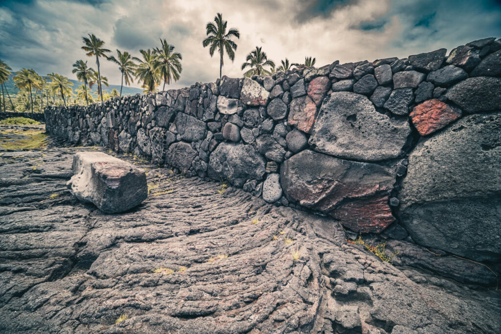 Puʻuhonua o Hōnaunau National Historical Park, Hōnaunau, Hawai'i (photo August 21, 2021): ʻĀleʻaleʻa heiau (māpele-style temple platform, burial site, and hula-viewing platform, oriented towards rising of star Arcturus) with Keōua Stone (partially-carved stone bench or canopy base).