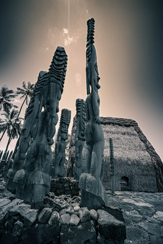 Puʻuhonua o Hōnaunau National Historical Park, Hōnaunau, Hawai'i (photo August 21, 2021): Hale o Keawe (mortuary temple built by or for ruler Keawe-i-kekahi-aliʻi-o-ka-moku c.1700, last restored 2004) with recreated ki'i (divinity statues).