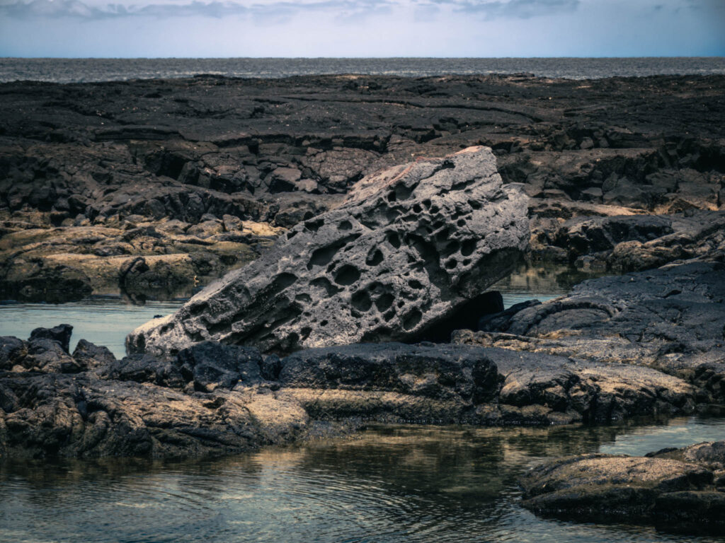 Puʻuhonua o Hōnaunau National Historical Park, Hōnaunau, Hawai'i (photo August 21, 2021): recreated ki'i (divinity statues) lava shelves ocean-side of Place of Refuge.