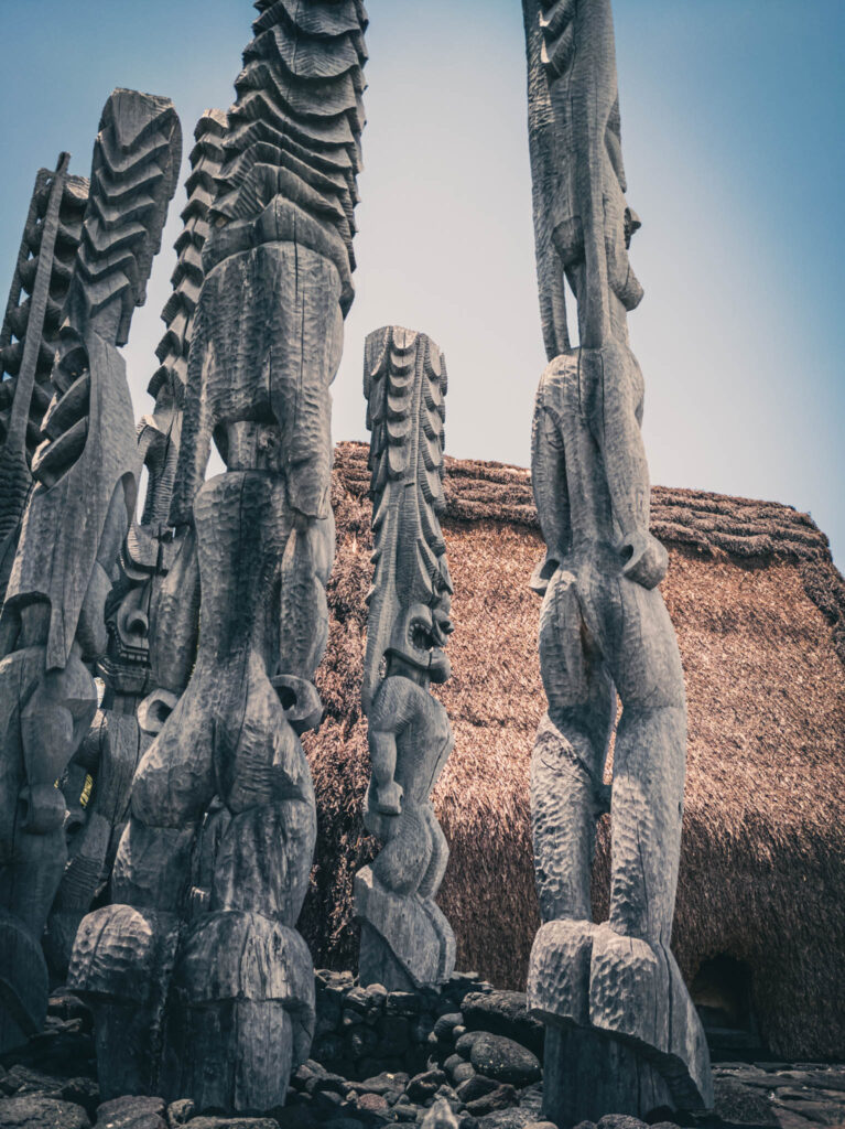 Puʻuhonua o Hōnaunau National Historical Park, Hōnaunau, Hawai'i (photo August 21, 2021): Hale o Keawe (mortuary temple built by or for ruler Keawe-i-kekahi-aliʻi-o-ka-moku c.1700, last restored 2004) with recreated ki'i (divinity statues).