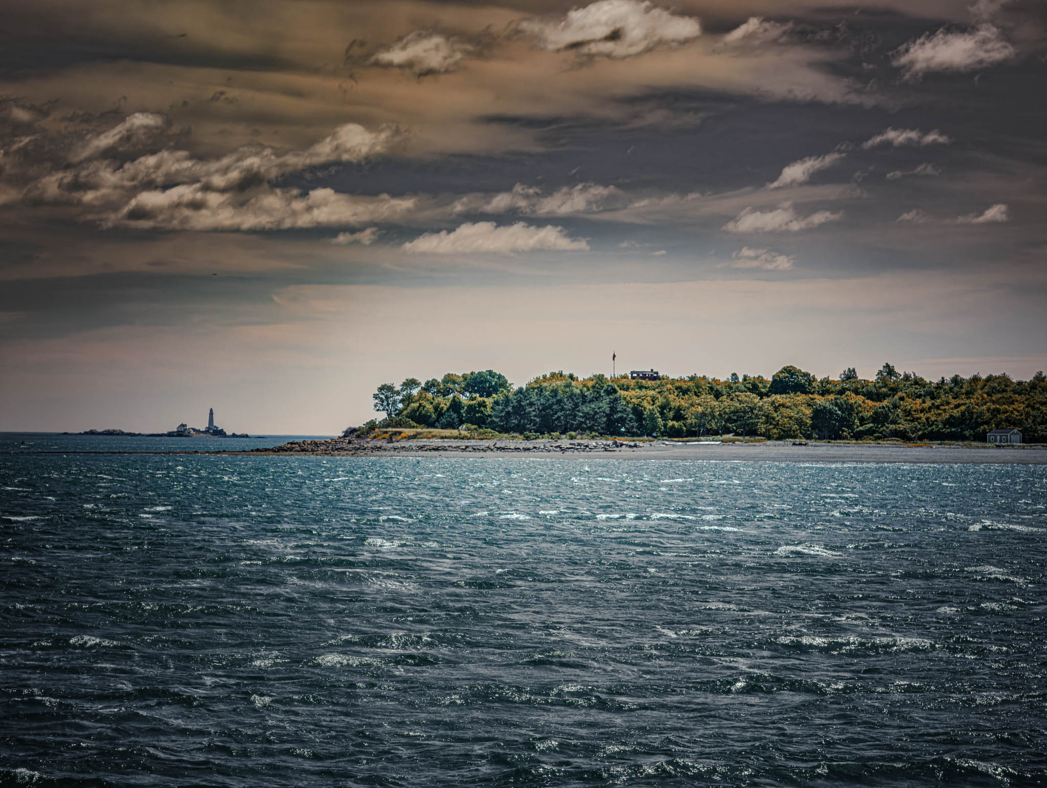 Boston Harbor (photo June 19, 2026) view from Nubble Channel of Georges Island, with Boston Light on Little Brewster Island far background.