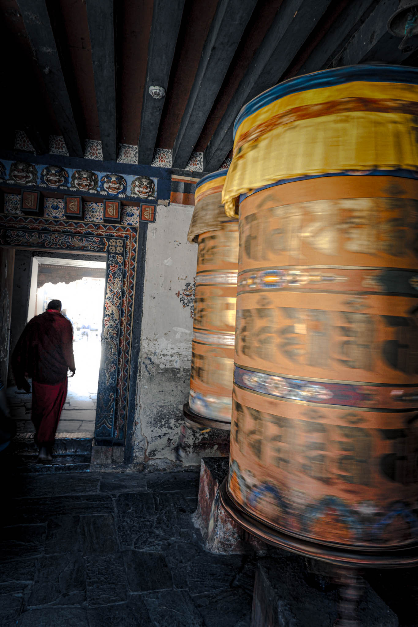 Jambay Lhakhang, Bumthang Valley, Bhutan, orig. 659 AD (photo Oct. 26, 2018) entrance to courtyard vestibule with "'khor lo" prayer wheels.
