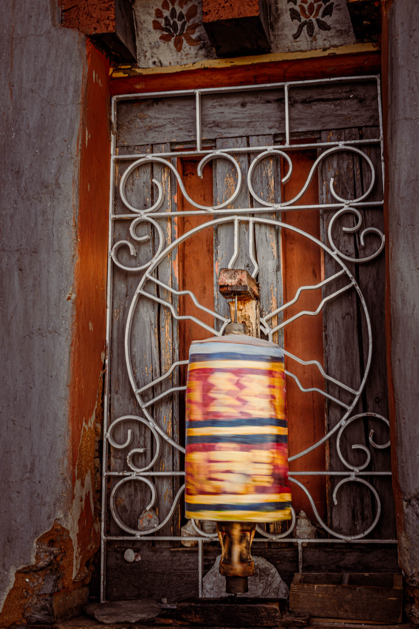 Jambay Lhakhang, Bumthang Valley, Bhutan, orig. 659 AD (photo Oct. 26, 2018) exterior window with "'khor lo" prayer wheel.