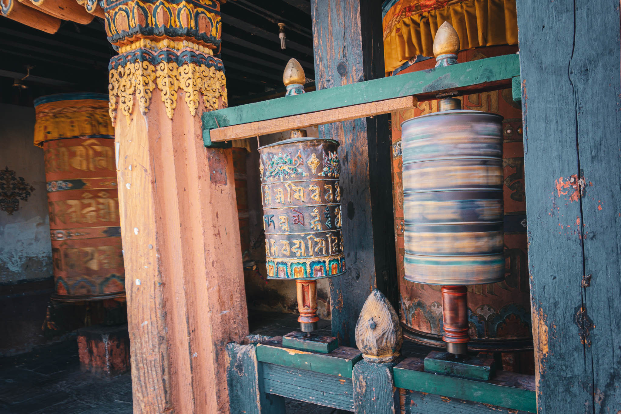 Jambay Lhakhang, Bumthang Valley, Bhutan, orig. 659 AD (photo Oct. 26, 2018) entrance to courtyard vestibule with "'khor lo" prayer wheels.