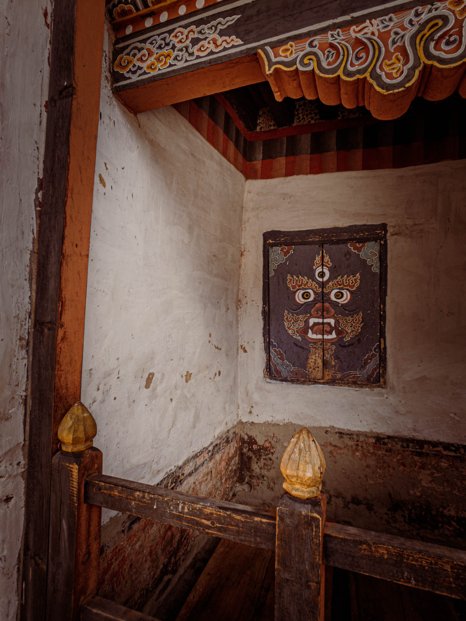 Jambay Lhakhang, Bumthang Valley, Bhutan, orig. 659 AD (photo Oct. 26, 2018) courtyard detail with painted face of "Mahakala" fierce protector.