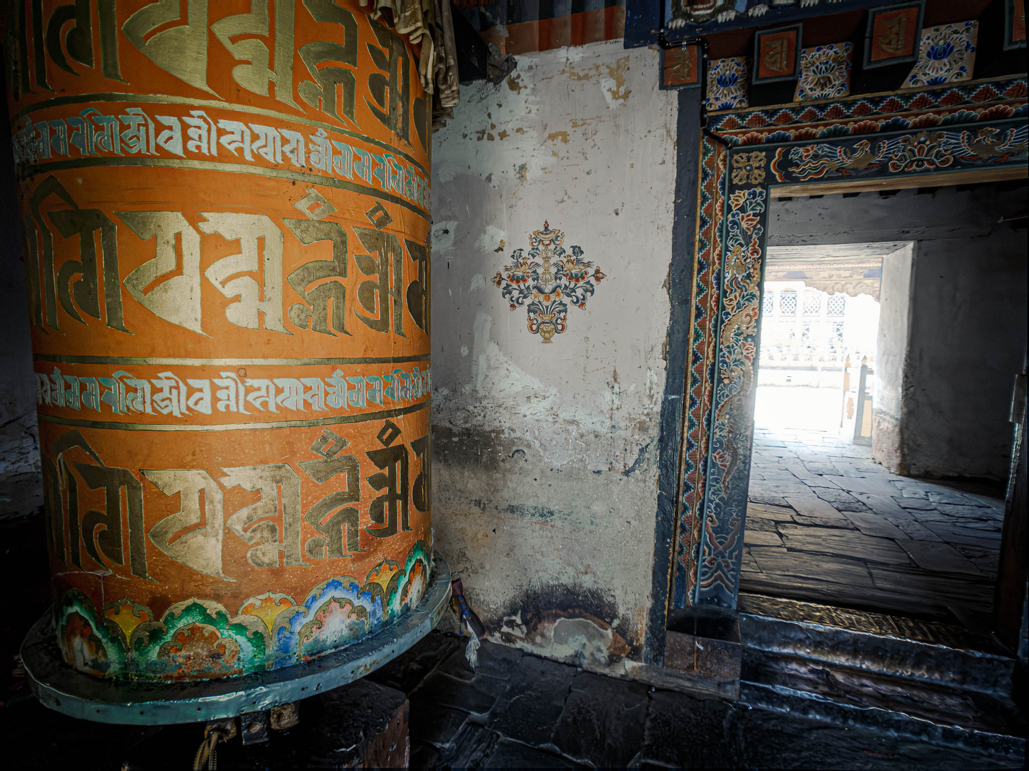 Jambay Lhakhang, Bumthang Valley, Bhutan, orig. 659 AD (photo Oct. 26, 2018) entrance to courtyard vestibule with "'khor lo" prayer wheels.
