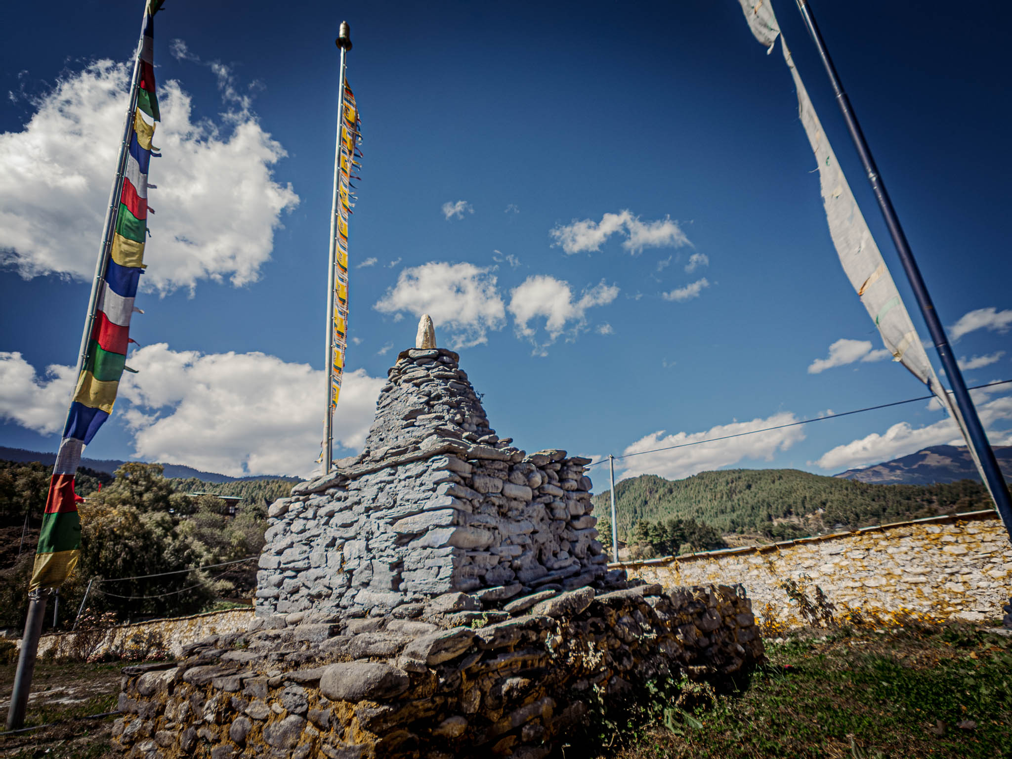 Jambay Lhakhang, Bumthang Valley, Bhutan, orig. 659 AD (photo Oct. 26, 2018) "chorten" with "darchog" vertical prayer flags.