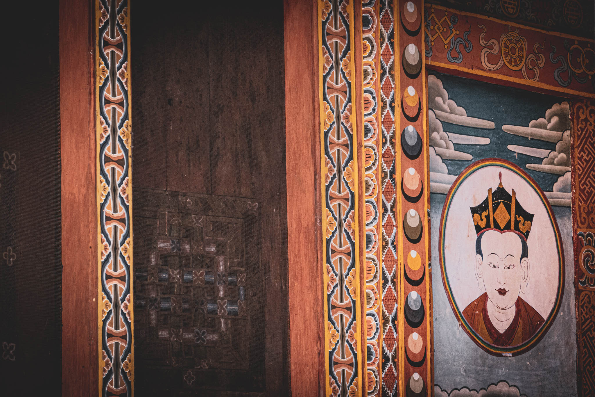 Jambay Lhakhang, Bumthang Valley, Bhutan, orig. 659 AD (photo Oct. 26, 2018) courtyard detail: mural with Guru Rinpoche portrait.