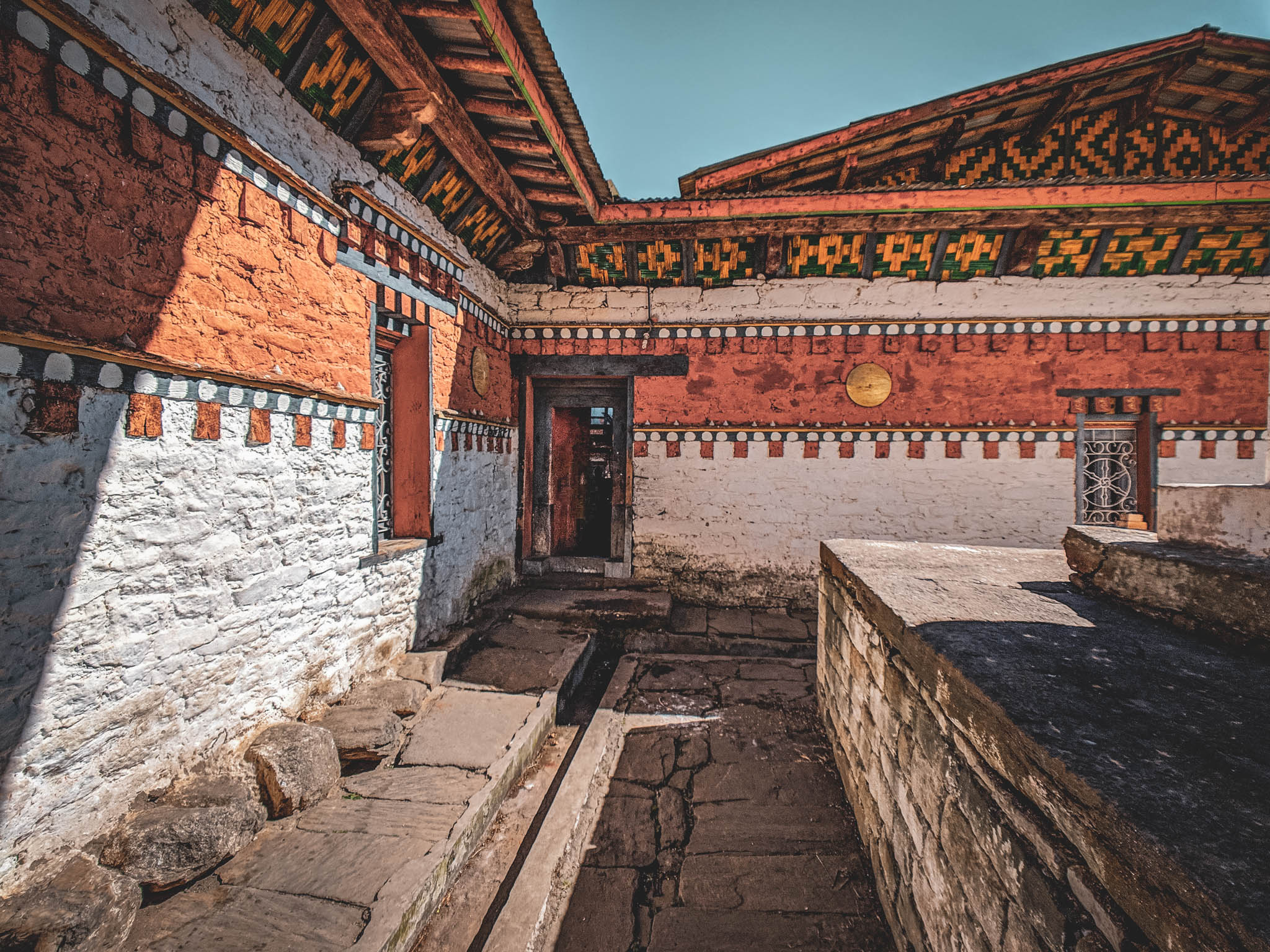Jambay Lhakhang, Bumthang Valley, Bhutan, orig. 659 AD (photo Oct. 26, 2018) west exterior detail, corner of original Jampa Lhakhang (left) and later Guru Lhakhang (right).