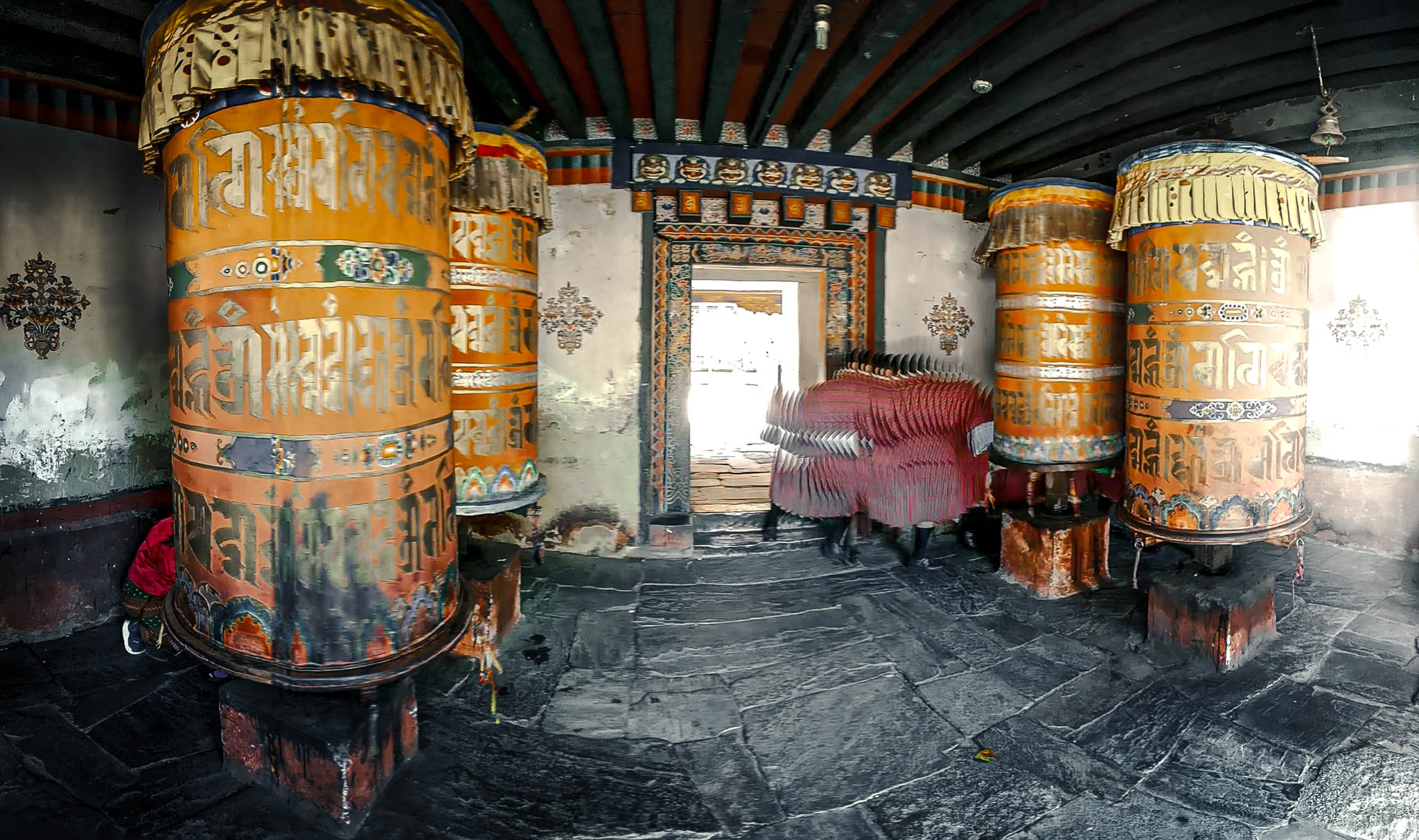 Jambay Lhakhang, Bumthang Valley, Bhutan, orig. 659 AD (photo Oct. 26, 2018) entrance to courtyard vestibule with "'khor lo" prayer wheels.