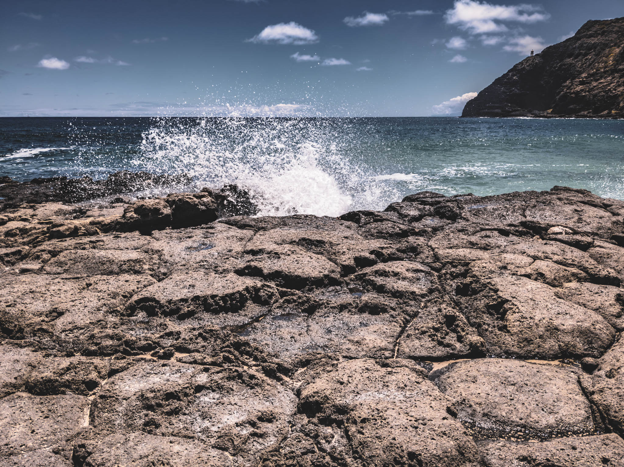 Makapu’u Point headland and lighthouse, Oahu Island (photo 17 August 2021), from from Makapuu Beach Park.