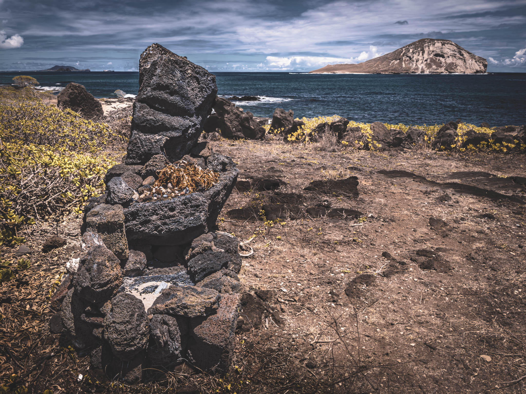 Makapu’u Heiau, Kalanianaʻole Highway, Oahu Island (photo 17 August 2021), with Kāohikaipu Islet (R) and Mānana Island (L) in far background.